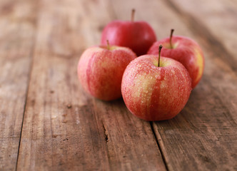 Ripe red apples on rustic wooden table - close up