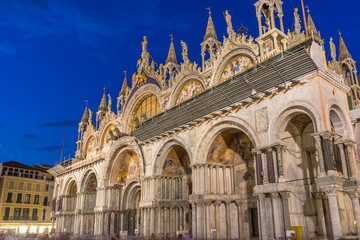 Naklejka premium Italy, Venice, St Mark's Basilica at night, LOW ANGLE VIEW OF TEMPLE BUILDING AGAINST BLUE SKY