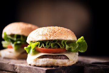 Homemade burger on wooden background.