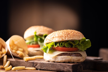 Homemade burger on wooden background.