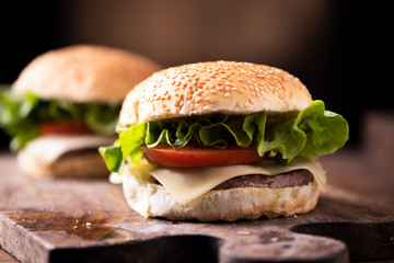 Homemade burger on wooden background.