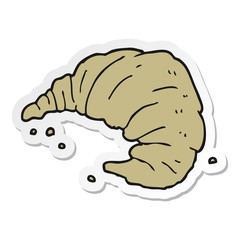 sticker of a cartoon croissant