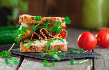 Homemade sandwich with cottage cheese, vegetables and radish sprouts
