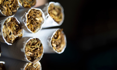 Close-up cigarette with black background. Visually highlighting unhealthy life