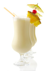 Pina colada with umbrella,pineapple and straw isolated on white
