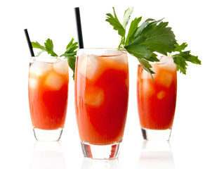 Red Bloody Mary drinks with ice cubes with celery isolated on white