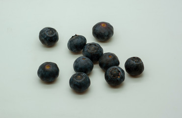 Purple blueberries on a neutral background