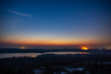 Burning grass in the field in the evening