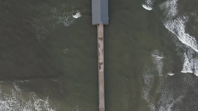 Aerial, overhead view of pier in Hanalei Bay, Hawaii