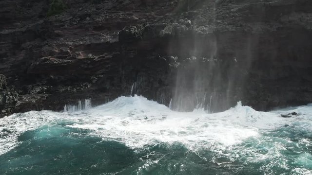 Ocean waves crash onto shore in Lahaina, Hawaii