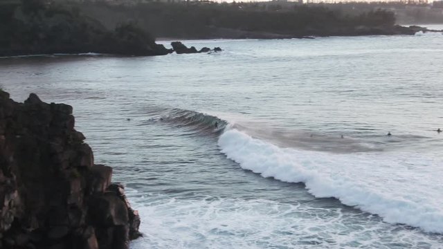 Aerial, surfer rides wave in Honokahua Bay, Hawaii