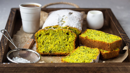 Homemade lemon poppy seed pound cake. Wooden background. Close up.