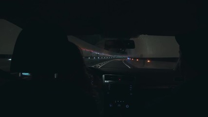 Couple on way to vacation or holiday destination, adventure seekers and inspirational wanderlust bloggers drive through empty futuristic tunnel with colorful lights. Concept future of driving