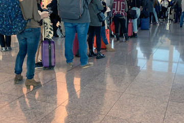 people standing in line at the airport on board the aircraft