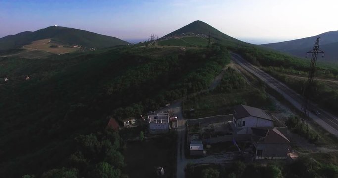 Aerial view of village houses and hills