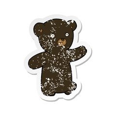 retro distressed sticker of a cartoon black bear cub