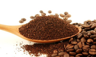 dark roasted coffee beans and ground coffee powder closeup on white background 