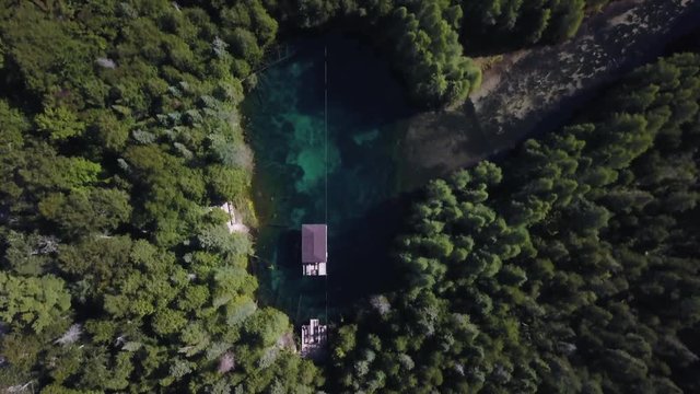 Overhead aerial, raft in Kitch Iti Kipi spring at Michigan state park