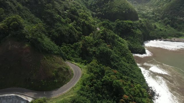 Aerial, Road to Hana cuts through forest on the coast of Maui, Hawaii