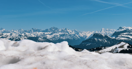 Beautiful spring panoramic view of snow-capped mountains in the Swiss Alps.