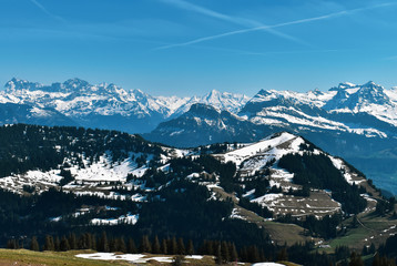 Beautiful spring panoramic view of snow-capped mountains in the Swiss Alps.