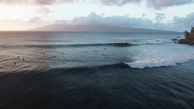 Surfers wait for waves in Honokahua Bay, Hawaii, aerial