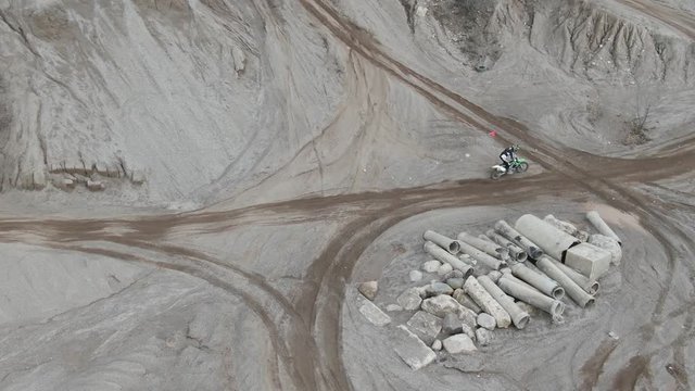 Dirt biker rides on track, aerial