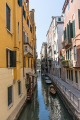 Fototapeta na wymiar Italy, Venice, a narrow city street with buildings in the background