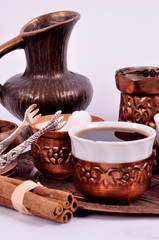 Coffee in copper coasters with accessories for coffee-drinking on a white background