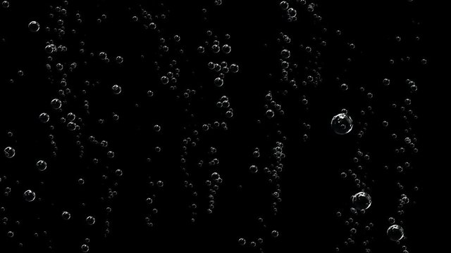 Bubbles of champagne thin threads rise to the top.Champagne bottle is opened and sprinkled. Slow motion, black background.