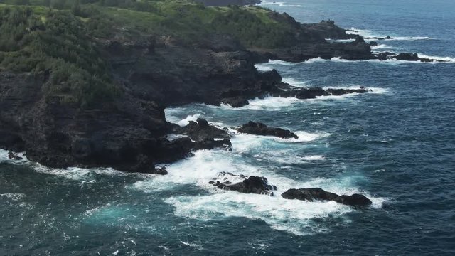 Aerial, waves crash on shore in Lahaina, Hawaii