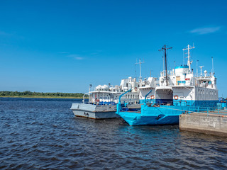 Naklejka premium Flota rzeczna. Statki są przy nabrzeżu. Transport ładunków rzekami. Firma żeglugowa.