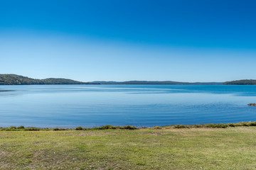 calm blue lake with clear blue sky 
