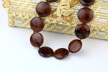 Beads made of natural obsidian stone,on a light background.