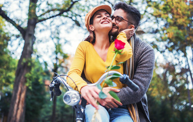 Couple in love. Romantic couple riding a bicycle in the park. Love, dating, romance