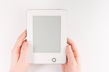 Holding E-book reader in hands. Book with hands isolated on white background