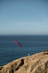 paraglider and surfer