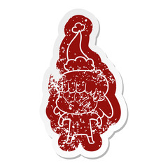 cartoon distressed sticker of a whistling girl wearing santa hat