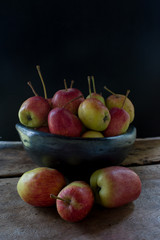 still life of apples in black clay bowl