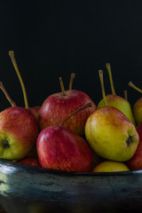 still life of apples in black clay bowl