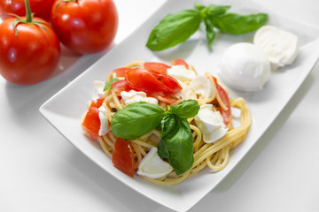Spaghetti with fresh tomatoes, basil, mozzarella and some oregano.