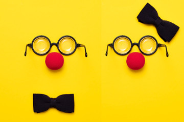 Funny glasses, red clown nose and tie lie on a colored background, like a face.