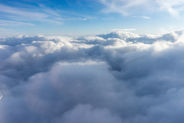 View from the sky, cloud, a plane flying through a cloudy blue sky