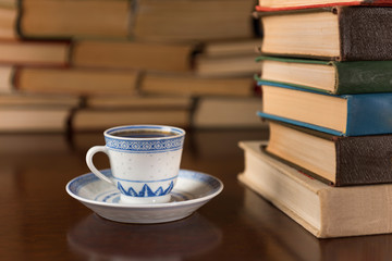 cup of coffee and piles of books