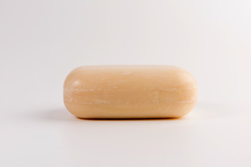 piece of beige soap isolated on a white background