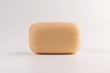 piece of beige soap isolated on a white background
