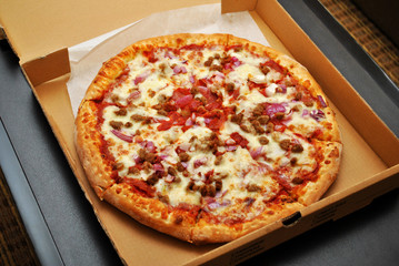 Meat Pizza with Onions in a Takeout Box
