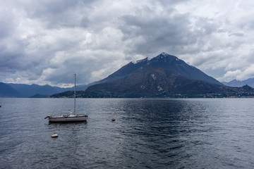 Italy, Varenna, Lake Como, Lake Atitl&aacute;n, a small boat in a body of water with Lake Atitl&aacute;n in the background