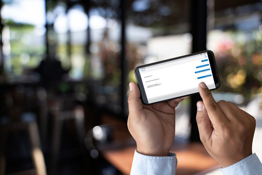man touch on button instant messaging app on mobile phone