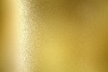 Glowing gold metallic wall, abstract texture background